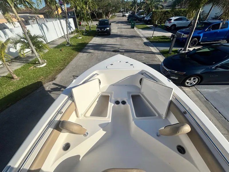 Slide: The Image of 2018 Key West 203 FS boat with open storage compartments, parked on a residential street. - 28