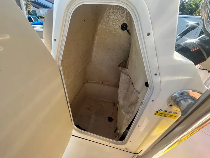 Slide: The Image of 2018 Key West 203 FS boat storage compartment with open door, showcasing interior space. - 29