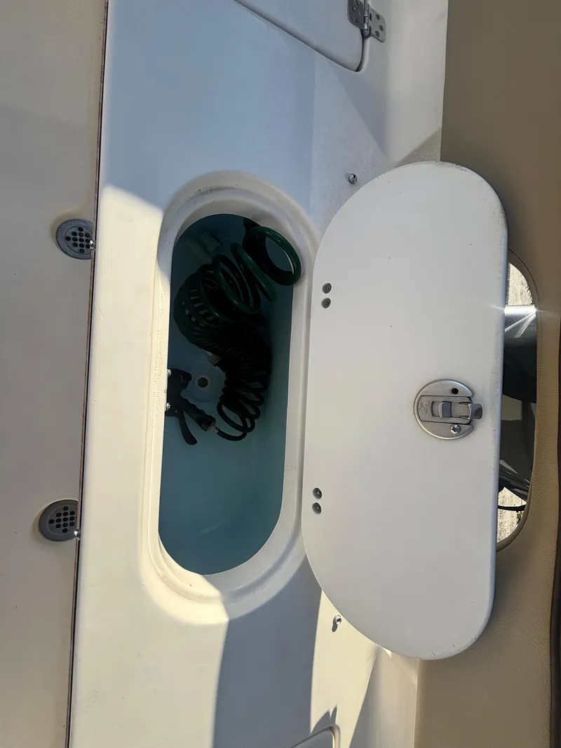 Slide: The Image of 2018 Key West 203 FS boat storage compartment with coiled rope inside. - 30