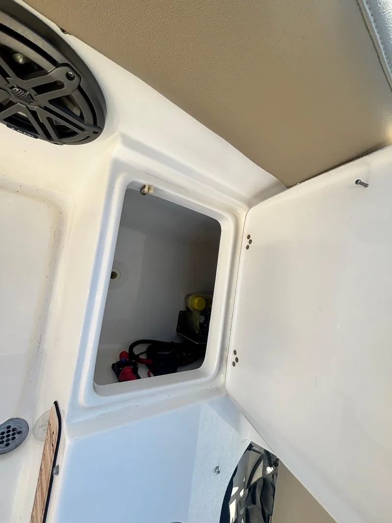 Slide: The Image of 2018 Key West 203 FS boat storage compartment with speaker and open hatch. - 32