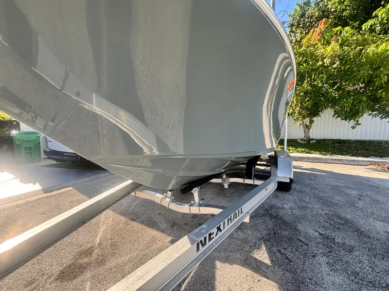 Slide: The Image of 2018 Key West 203 FS boat on trailer, parked outdoors in sunny setting. - 4