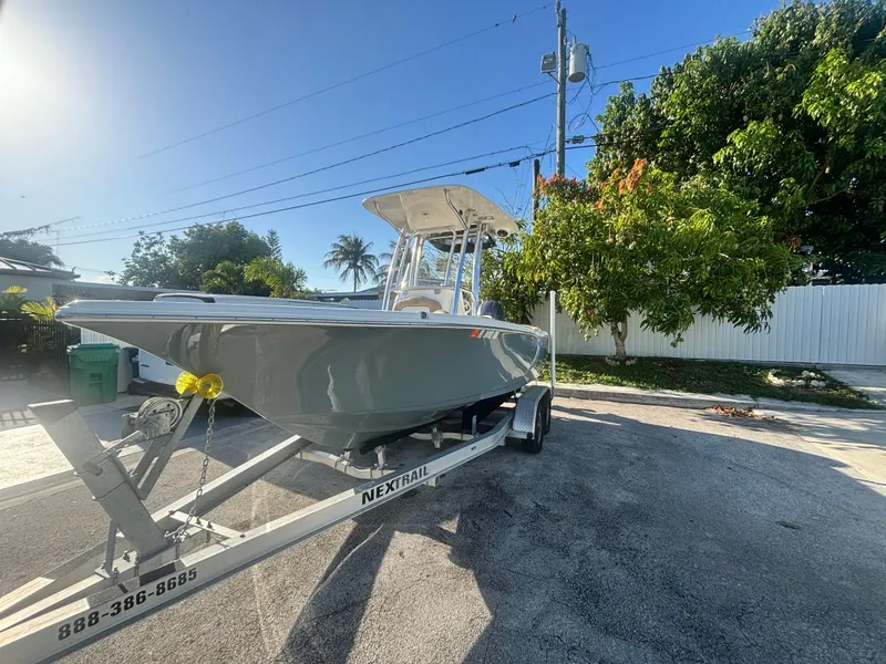 Slide: The Image of 2018 Key West 203 FS boat on trailer, parked outdoors under clear sky. - 5