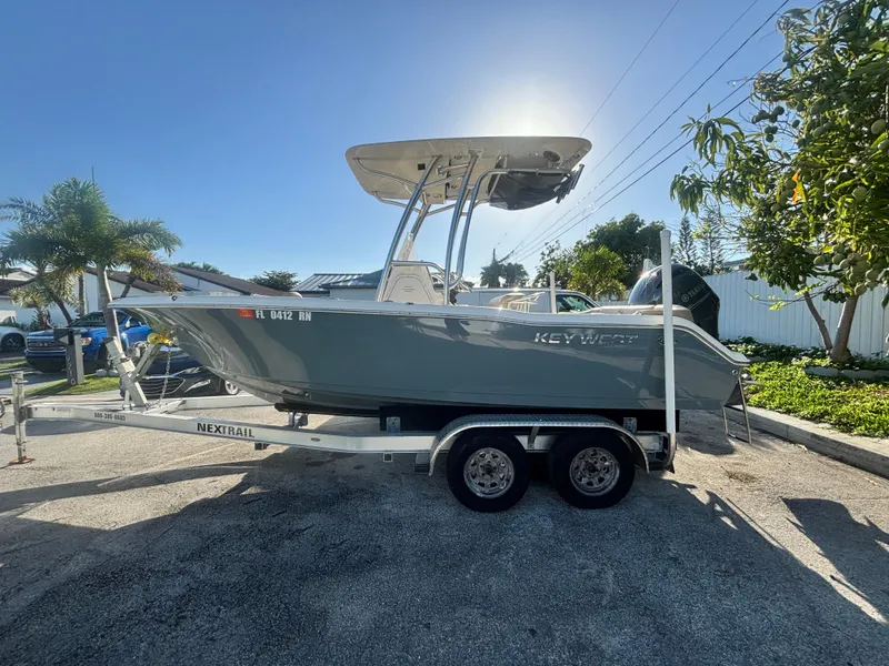 Slide: The Image of 2018 Key West 203 FS boat on trailer, parked outdoors under clear sky. - 6