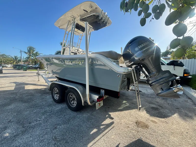 Slide: The Image of 2018 Key West 203 FS boat on trailer with Yamaha outboard motor, parked outdoors. - 7