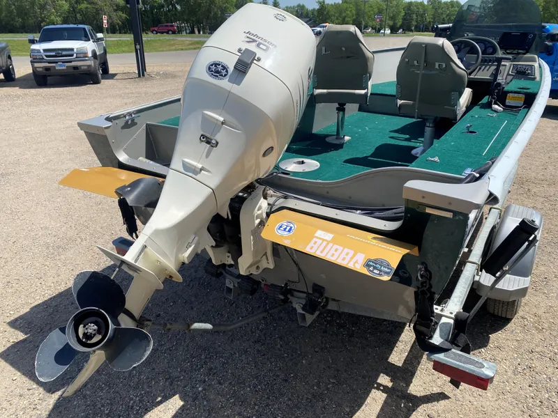 Slide: The Image of 2002 Lund 1650 Explorer boat with Johnson outboard motor, parked on a trailer. - 10