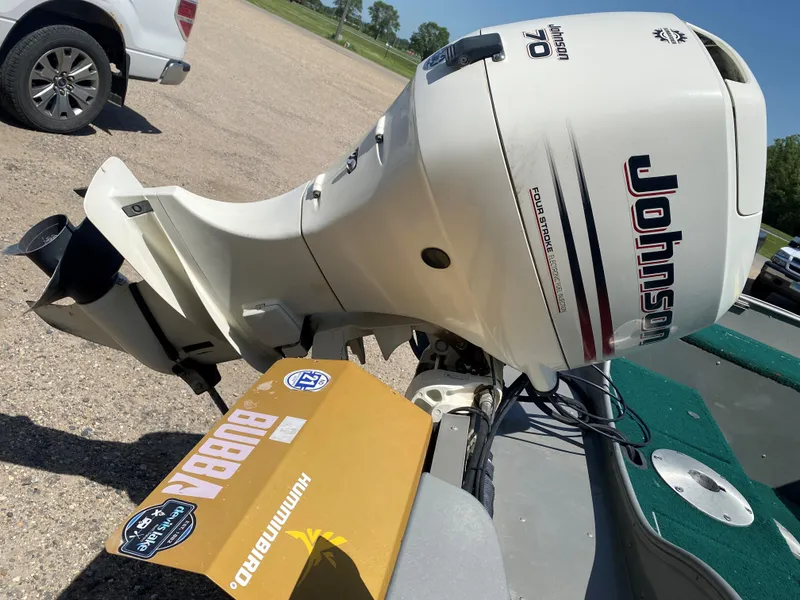 Slide: The Image of 2002 Lund 1650 Explorer with Johnson 70 outboard motor in a parking lot. - 11