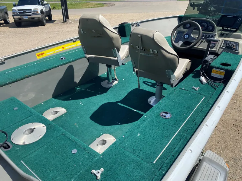 Slide: The Image of 2002 Lund 1650 Explorer boat interior with green carpet and two seats. - 25