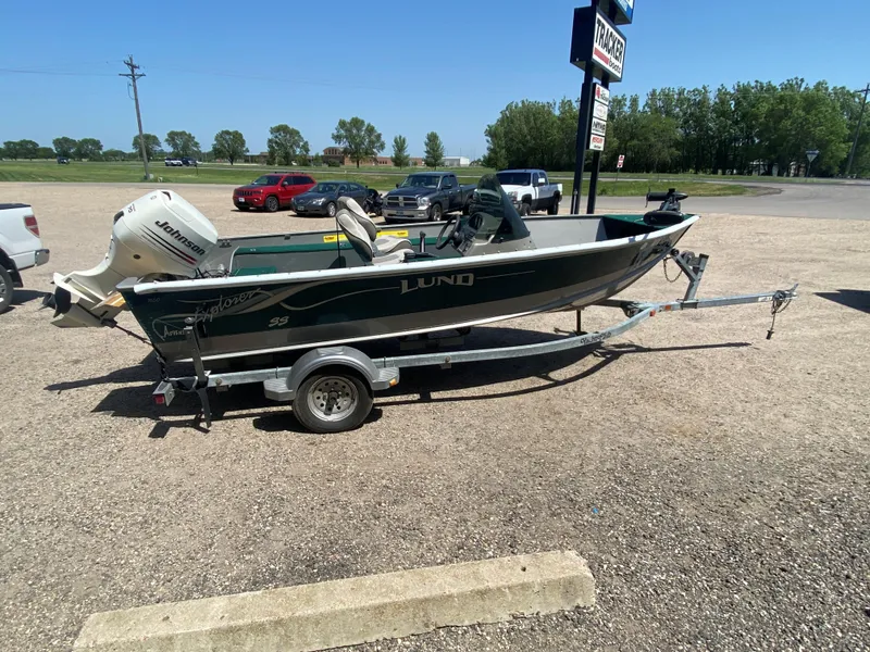 Slide: The Image of 2002 Lund 1650 Explorer boat on trailer with Johnson outboard motor. - 5