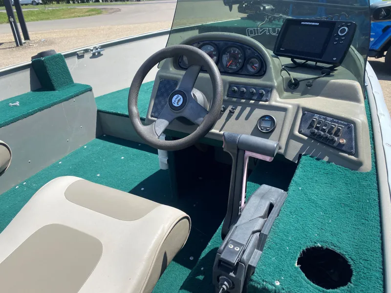 Slide: The Image of 2002 Lund 1650 Explorer boat interior with steering wheel and control panel. - 12