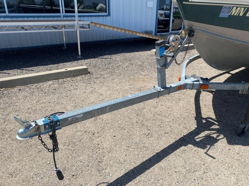 Slide: The Image of Trailer hitch of a 2002 Lund 1650 Explorer boat in a parking lot. - 6
