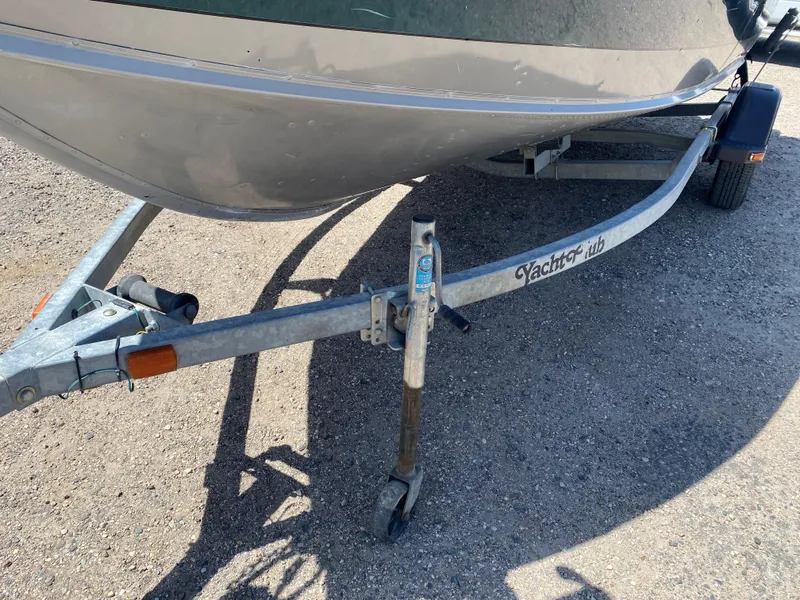 Slide: The Image of 2002 Lund 1650 Explorer boat on a Yacht Club trailer, parked on gravel. - 7