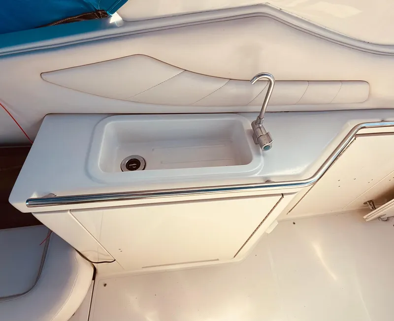 Slide: The Image of 1997 Regal 320 Commodore boat sink with faucet, white interior design. - 11
