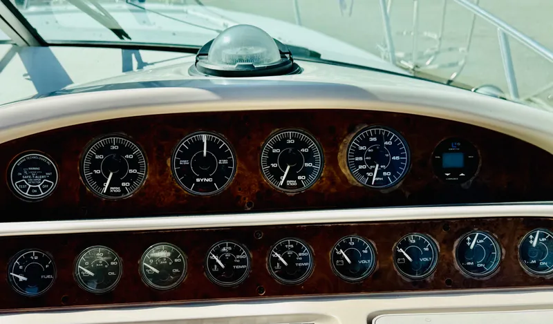 Slide: The Image of Dashboard of a 1997 Regal 320 Commodore boat with various gauges and controls. - 17