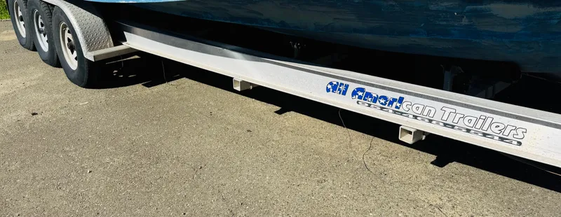 Slide: The Image of Trailer for 1997 Regal 320 Commodore boat on pavement. - 2