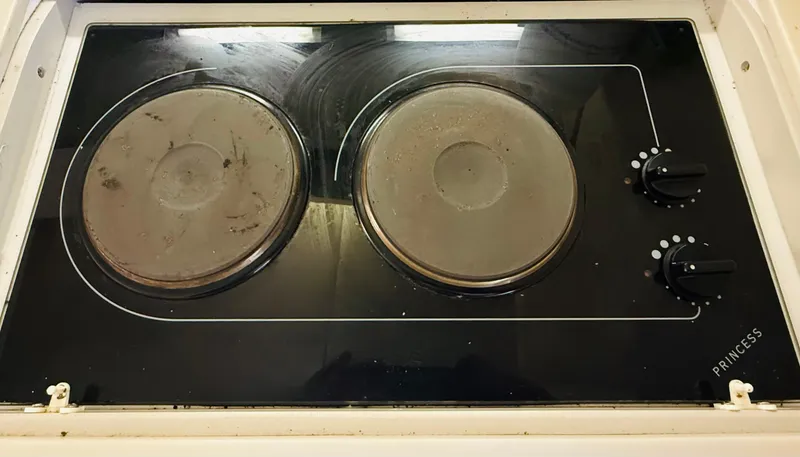 Slide: The Image of Electric stove with two burners and control knobs on a Regal 320 Commodore, 1997 model. - 27