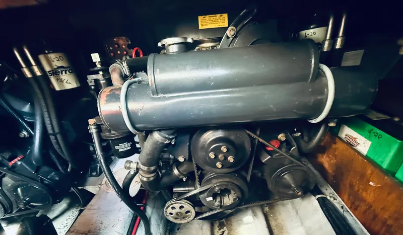 Slide: The Image of Engine compartment of a 1997 Regal 320 Commodore boat, showcasing mechanical components. - 34