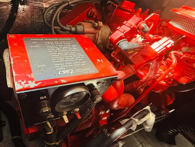 Slide: The Image of Engine compartment of a 1997 Regal 320 Commodore with red components and generator. - 37
