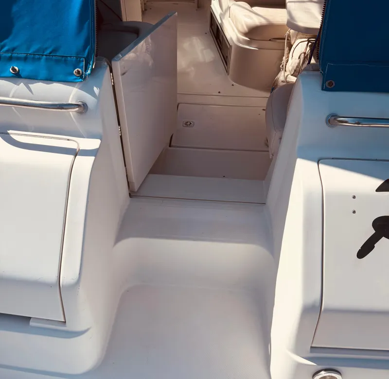 Slide: The Image of 1997 Regal 320 Commodore boat interior with blue accents and seating area. - 9