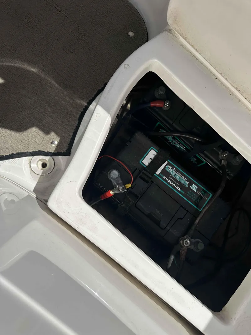 Slide: The Image of Battery compartment of a 2003 Glastron DX 235 boat, showing wiring and connections. - 12