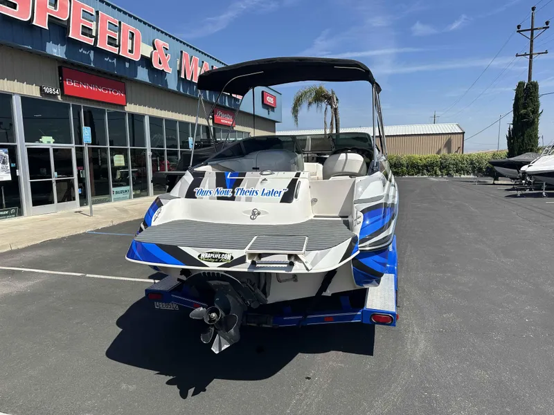 Slide: The Image of 2003 Glastron DX 235 boat parked outside dealership, rear view. - 16