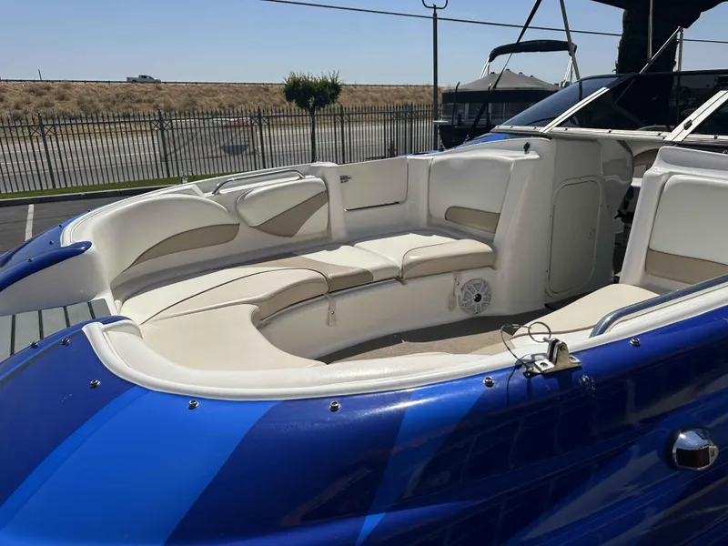 Slide: The Image of 2003 Glastron DX 235 boat interior with white seating and blue exterior. - 5