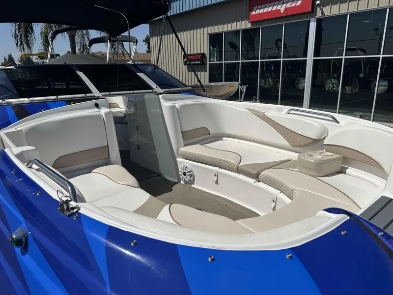 Slide: The Image of 2003 Glastron DX 235 boat with spacious seating and modern design. - 7