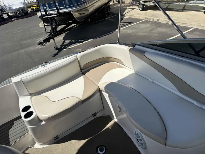 Slide: The Image of 2003 Glastron DX 235 boat interior with beige seating and cup holders. - 8