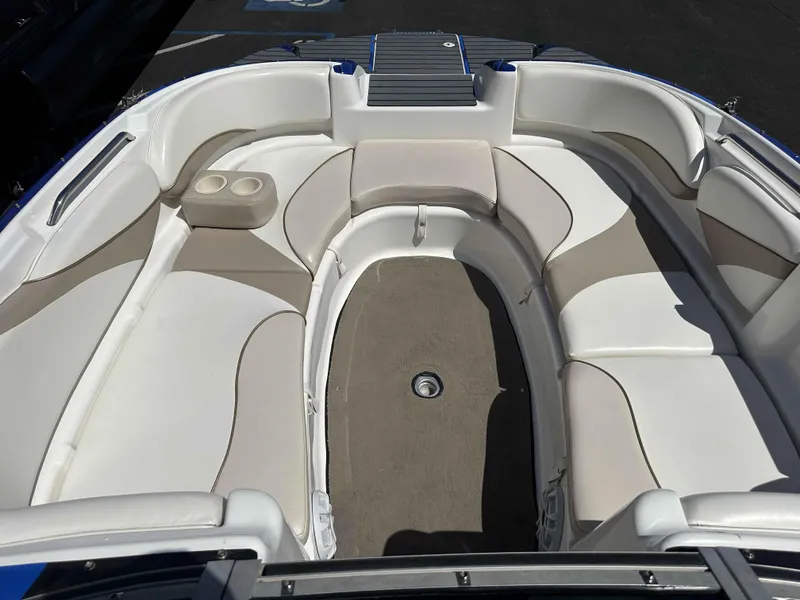 Slide: The Image of 2003 Glastron DX 235 boat interior with beige and white seating arrangement. - 9
