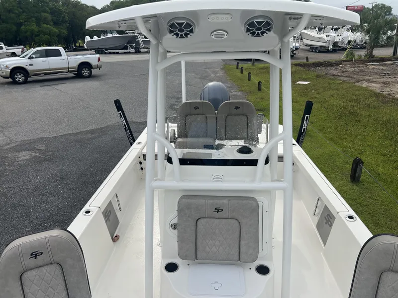 Slide: The Image of 2021 Sea Pro 228 Bay boat interior with seating and console, parked outdoors. - 9