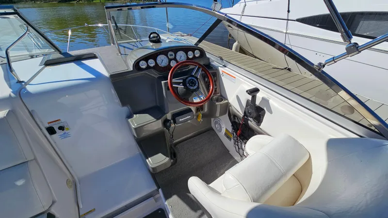 Slide: The Image of 2008 Regal 2565 Window Express boat cockpit with steering wheel and dashboard controls. - 11