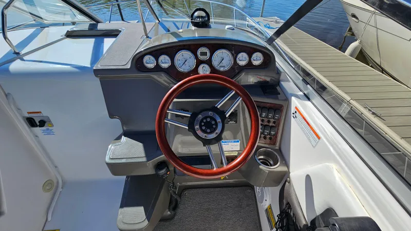 Slide: The Image of 2008 Regal 2565 Window Express boat dashboard with wood steering wheel and gauges. - 12