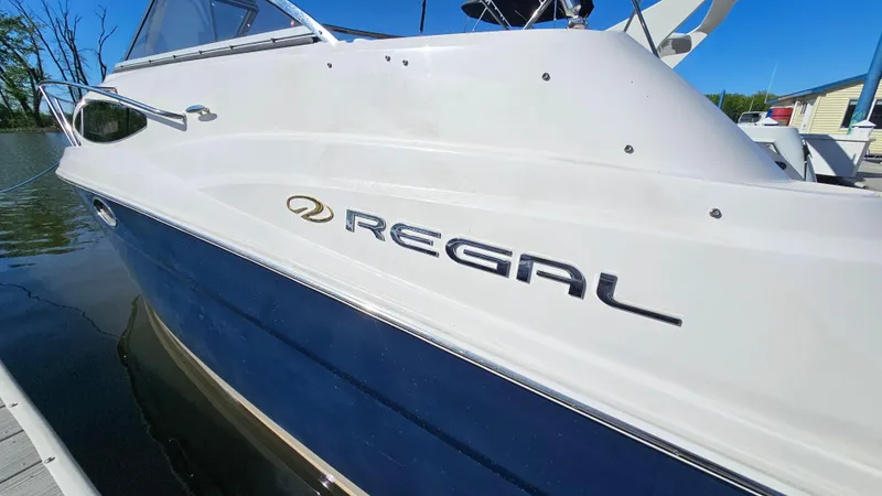 Slide: The Image of 2008 Regal 2565 Window Express boat docked, showcasing sleek design and branding. - 25