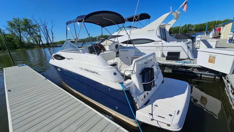 Slide: The Image of 2008 Regal 2565 Window Express boat docked at marina under clear blue sky. - 3