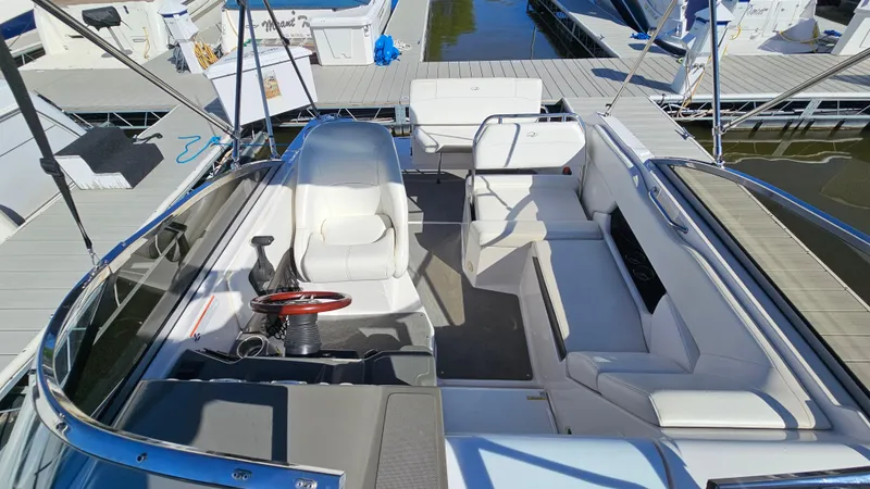 Slide: The Image of 2008 Regal 2565 Window Express boat interior with seating and steering wheel at marina. - 5