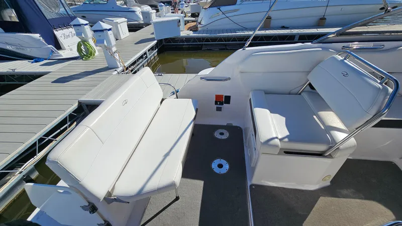 Slide: The Image of 2008 Regal 2565 Window Express boat interior with white seating at dock. - 6
