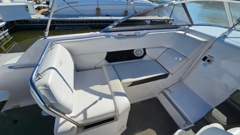 Slide: The Image of 2008 Regal 2565 Window Express boat interior with white seating and dashboard. - 9