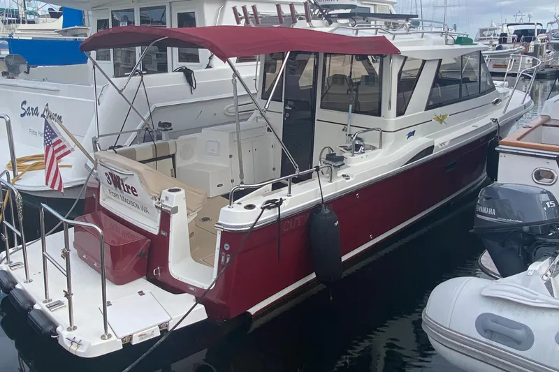 The Image of 2015 Cutwater C-28 boat docked with red canopy and American flag. - 0