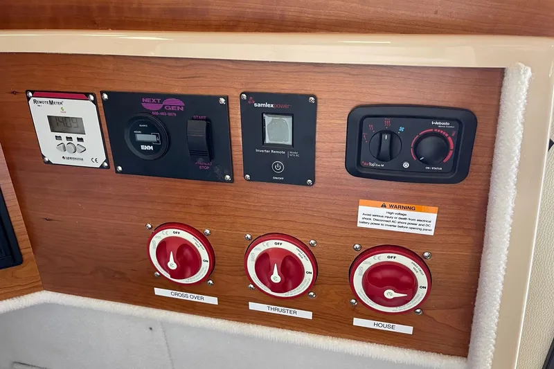 Slide: The Image of Control panel of a 2015 Cutwater C-28 boat with various switches and dials. - 19