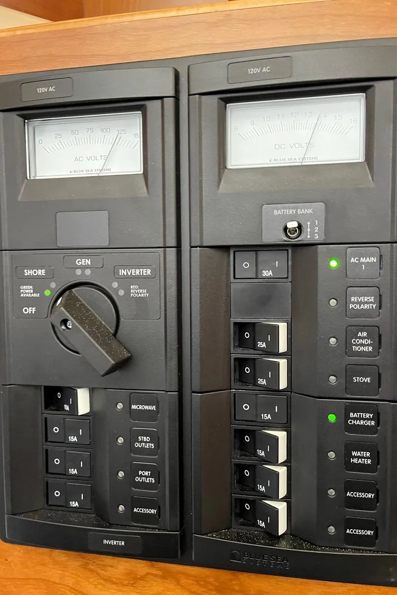 Slide: The Image of Electrical control panel on a 2015 Cutwater C-28 boat, featuring switches and meters. - 20