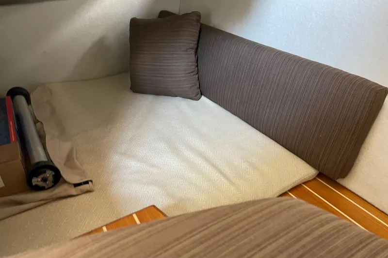 Slide: The Image of Interior cabin of 2015 Cutwater C-28 boat with brown cushions and wooden flooring. - 22