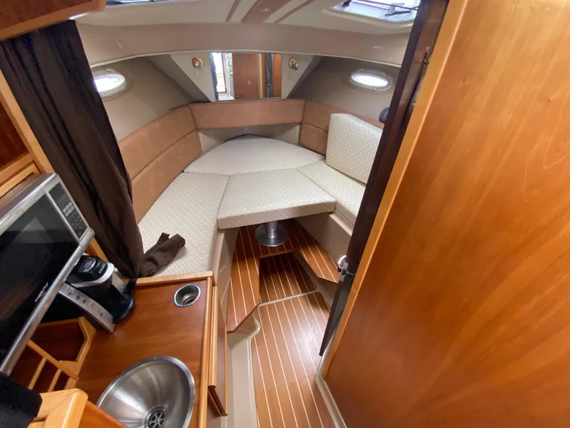 Slide: The Image of 2015 Cutwater C-28 cabin interior with kitchenette and seating area. - 26