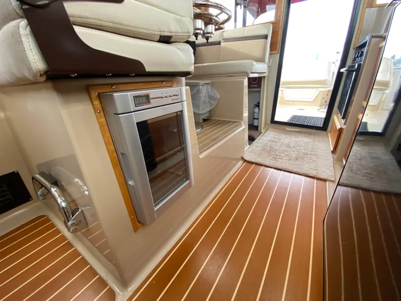 Slide: The Image of Interior of 2015 Cutwater C-28 boat with wood flooring and built-in appliances. - 30