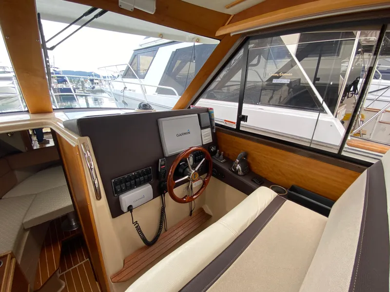 Slide: The Image of Interior of 2015 Cutwater C-28 boat with steering wheel and navigation equipment. - 33