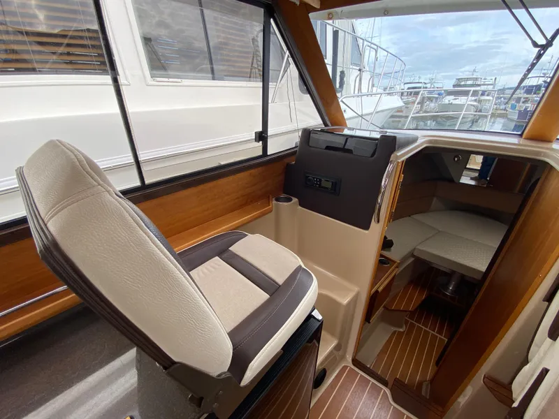 Slide: The Image of 2015 Cutwater C-28 boat interior with helm seat and cabin view. - 35