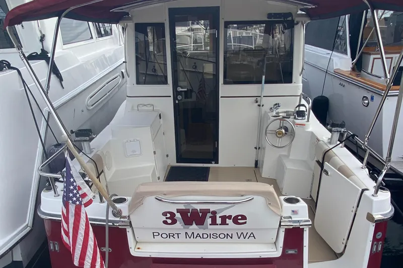 Slide: The Image of 2015 Cutwater C-28 boat docked, rear view with "3Wire" and American flag. - 40