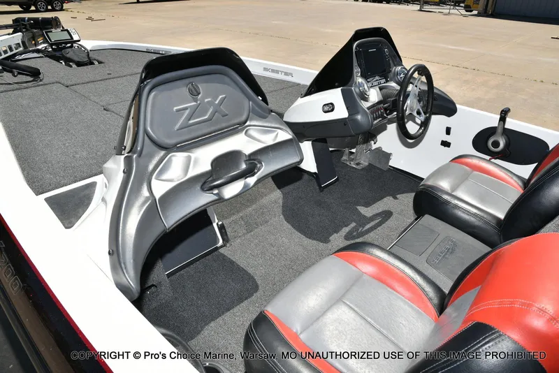 Slide: The Image of 2013 Skeeter ZX200 boat interior with steering wheel and seating. - 10
