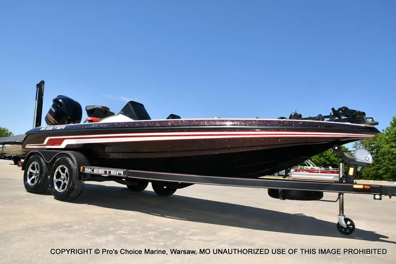 Slide: The Image of 2013 Skeeter ZX200 boat on trailer under clear blue sky. - 13