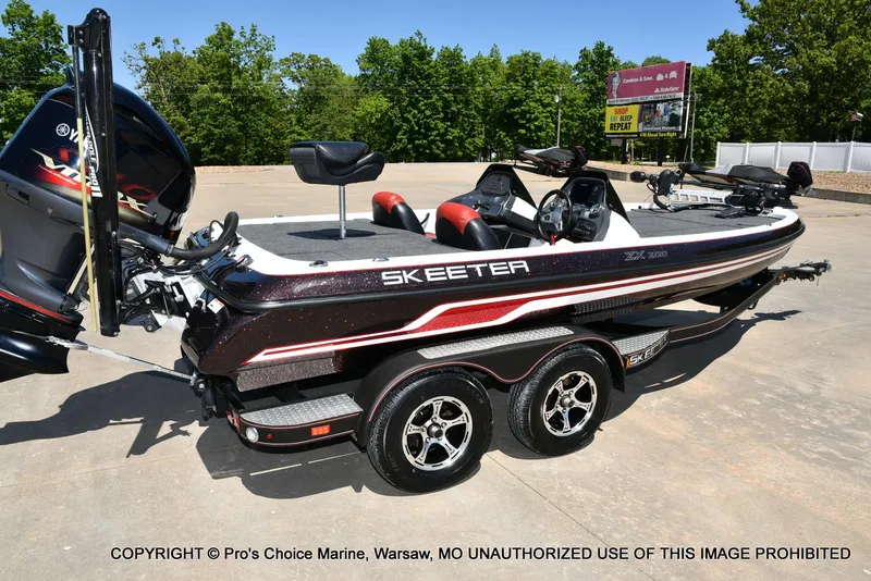Slide: The Image of 2013 Skeeter ZX200 boat on trailer, featuring sleek design and dual seats. - 14