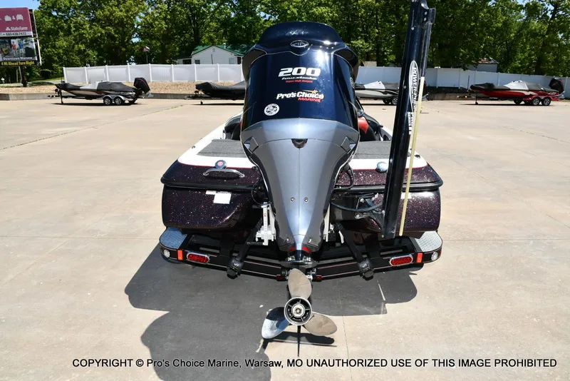 Slide: The Image of 2013 Skeeter ZX200 boat with powerful outboard motor, parked on concrete lot. - 22