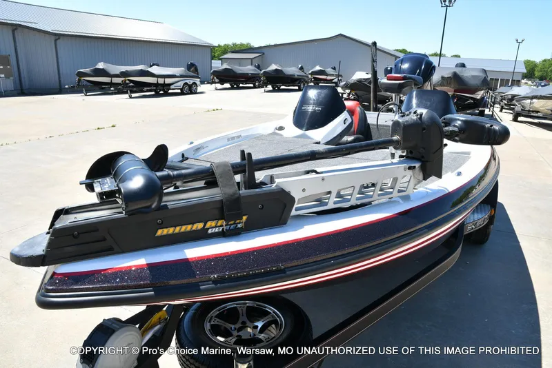 Slide: The Image of 2013 Skeeter ZX200 boat with Minn Kota trolling motor in a marina setting. - 27